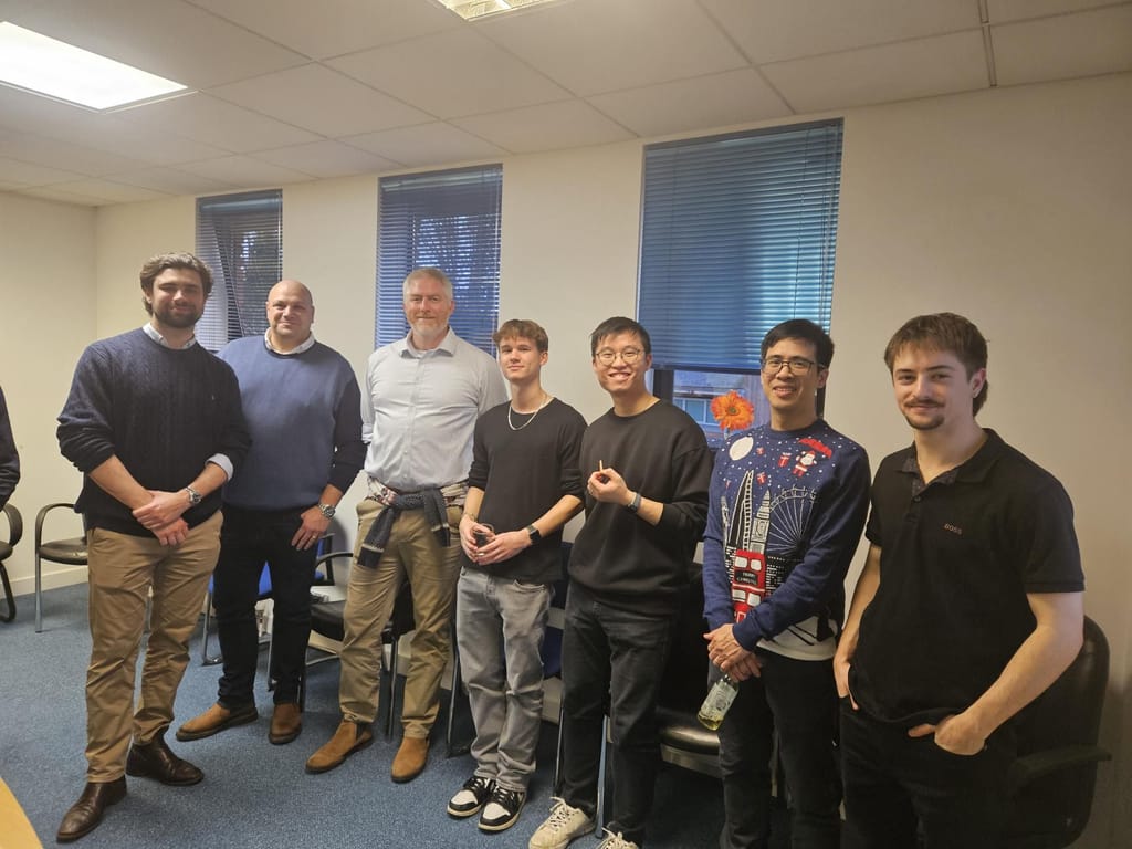 A group of colleagues standing together in the office