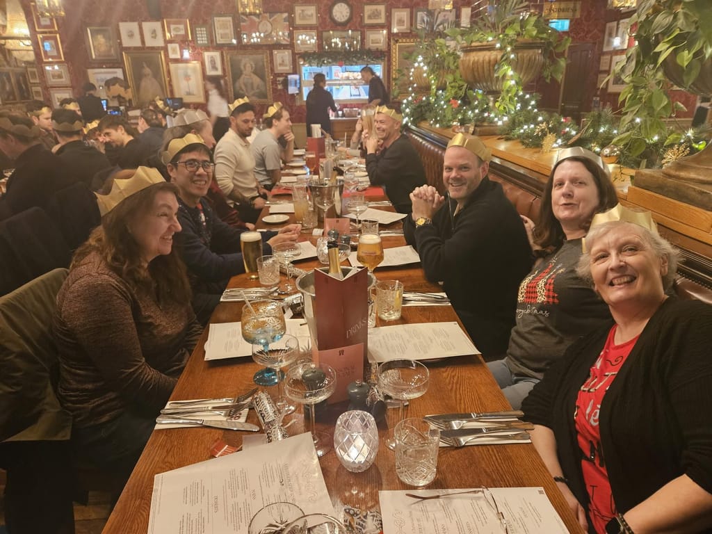 Colleagues seated at a long table for the Christmas meal