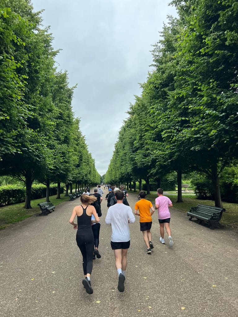 Runners on a tree-lined avenue